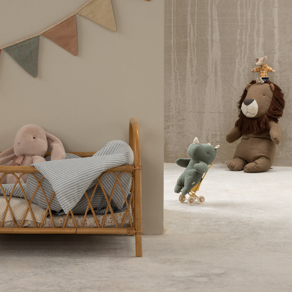 Children's room with wooden crib, plush toys, and decorative elements.