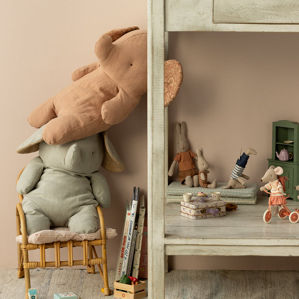 Children's room with stuffed animals, books, and toys on a shelf.