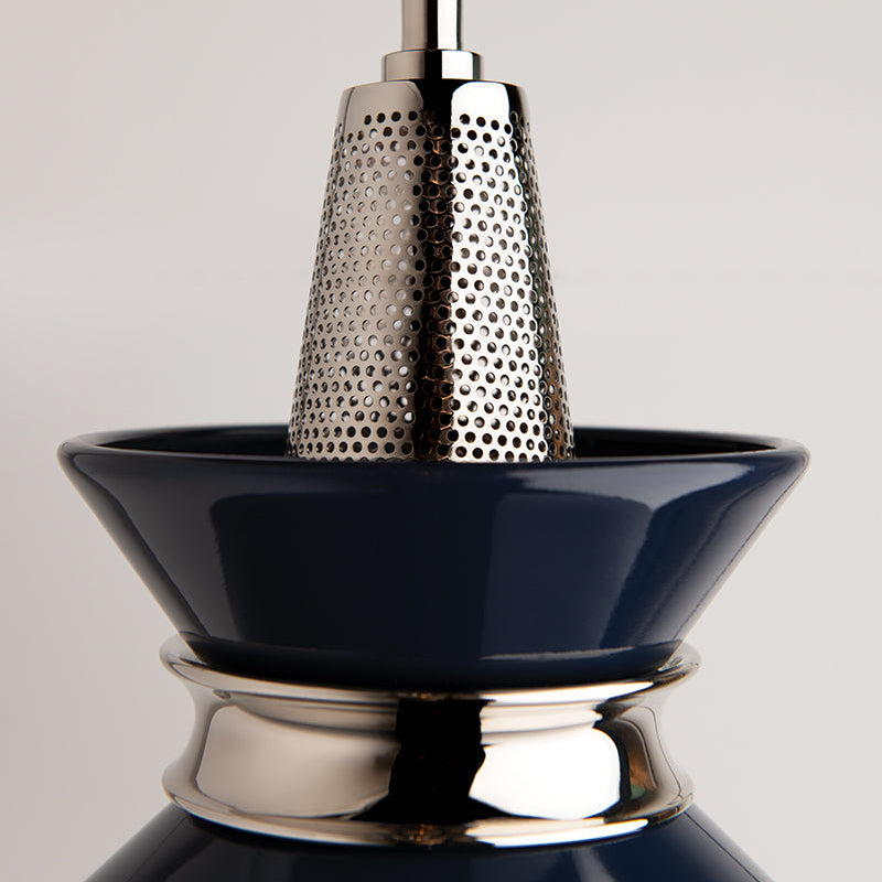 Close-up of a black and silver kitchen grater on a light gray background