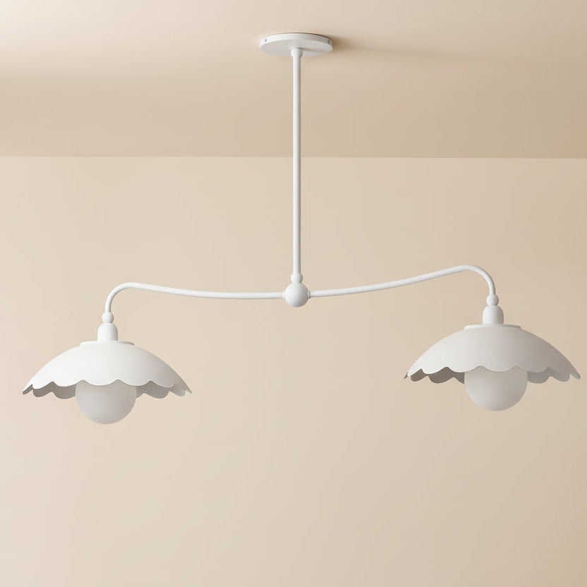 White pendant light with scalloped edges on a plain background