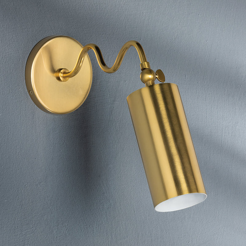 Gold wall-mounted lamp on a gray background