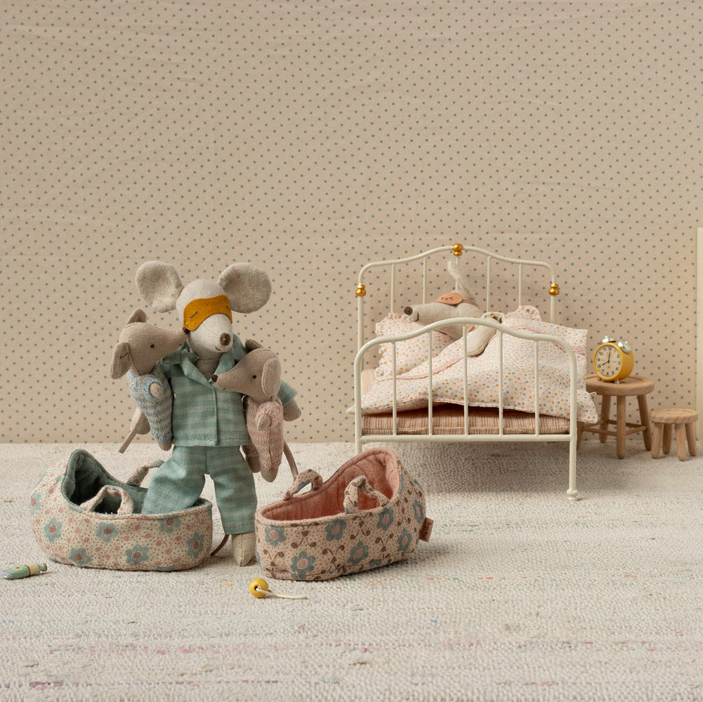 Miniature bedroom scene with toys and furniture in a child's room.