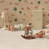 Children's room with toys and a patterned wall featuring animals and trees.