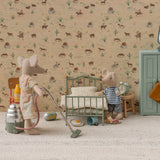 Miniature scene with toy mice in a room setting, including a bed and dresser, with a patterned wallpaper background.