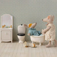 Miniature bathroom set with toys including a bathtub and toilet.