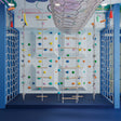 Children's indoor play area with climbing wall and colorful decorations