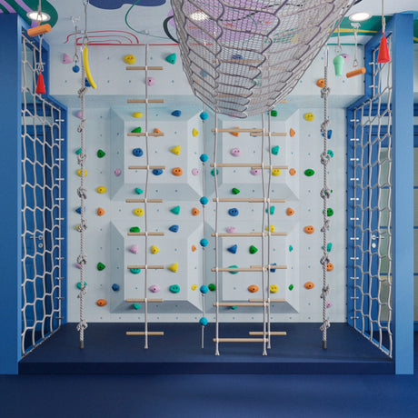Children's indoor play area with climbing wall and colorful decorations