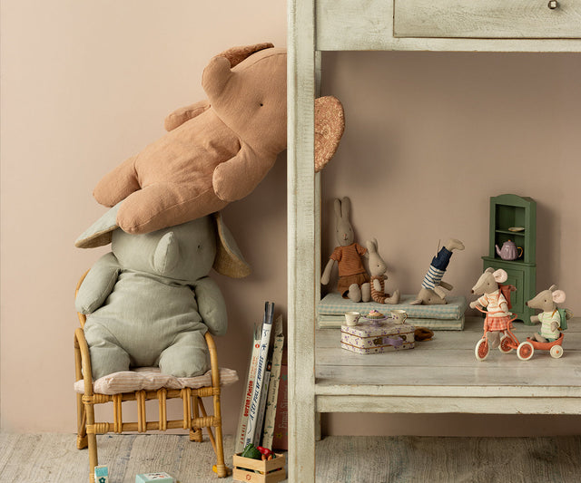 Children's room with stuffed animals, books, and toys on a shelf.