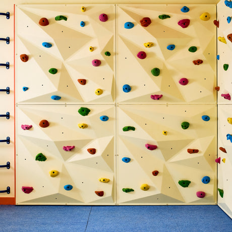 Colorful climbing wall with holds and handholds in an indoor setting