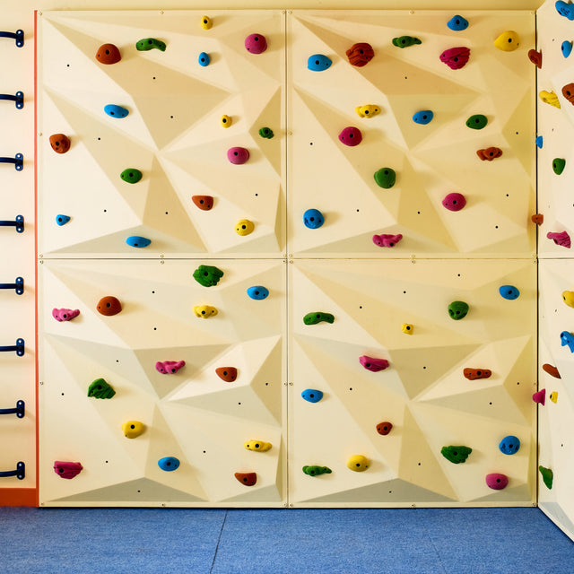 Colorful climbing wall with holds and handholds in an indoor setting