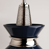 Close-up of a black and silver kitchen grater on a light gray background