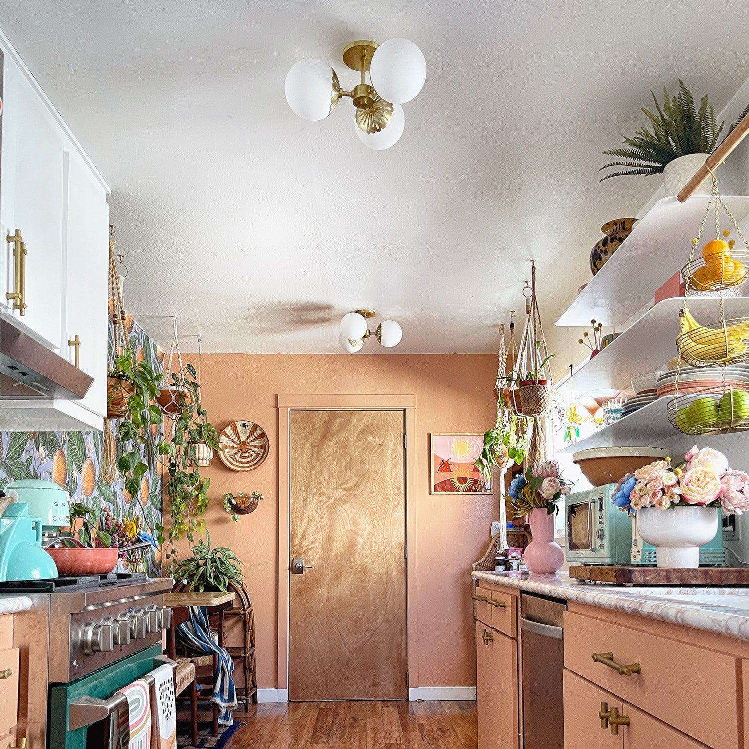 Kitchen with wooden cabinets, a rug on the floor, and various decor items.