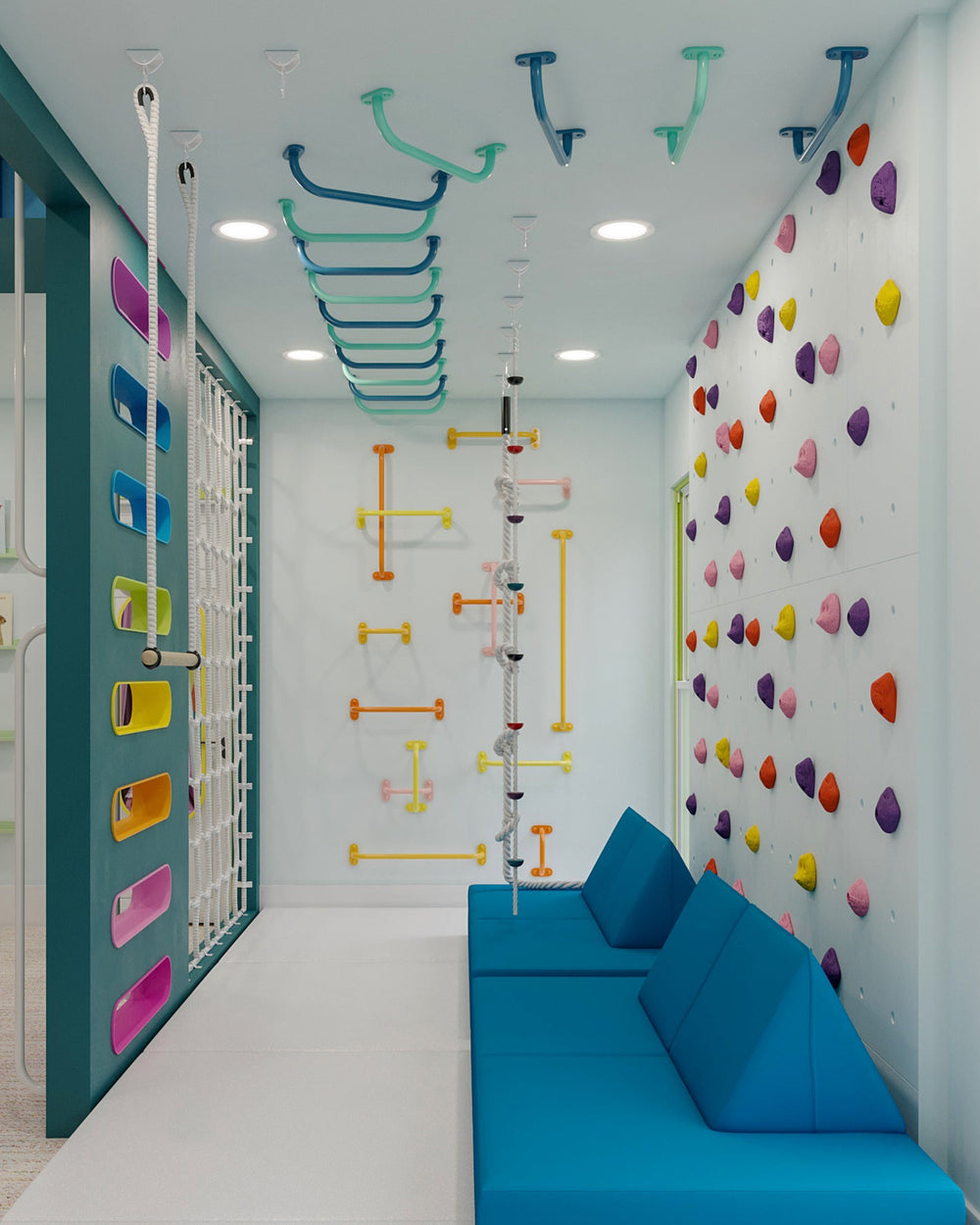 A bright children's playroom or gym corridor with colorful climbing walls, ceiling climbing bars, a blue bench, and large windows.