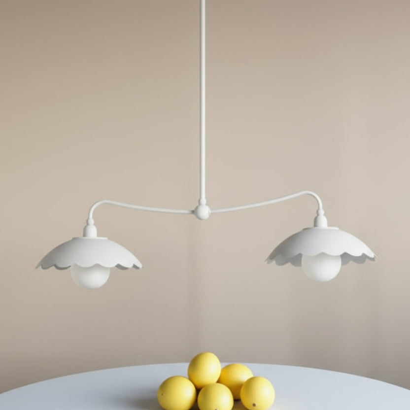 Pair of white pendant lights with floral patterned wallpaper