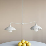 Pair of white pendant lights with floral patterned wallpaper