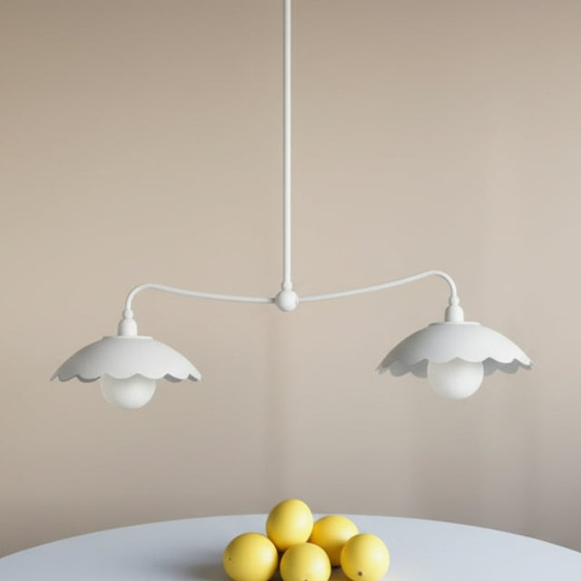 Pair of white pendant lights with floral patterned wallpaper
