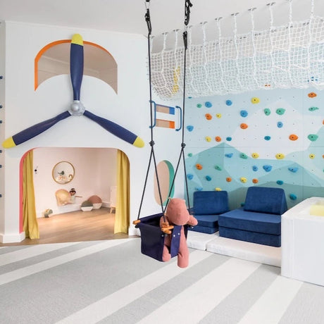 Children's playroom with colorful walls, swing, and slide.