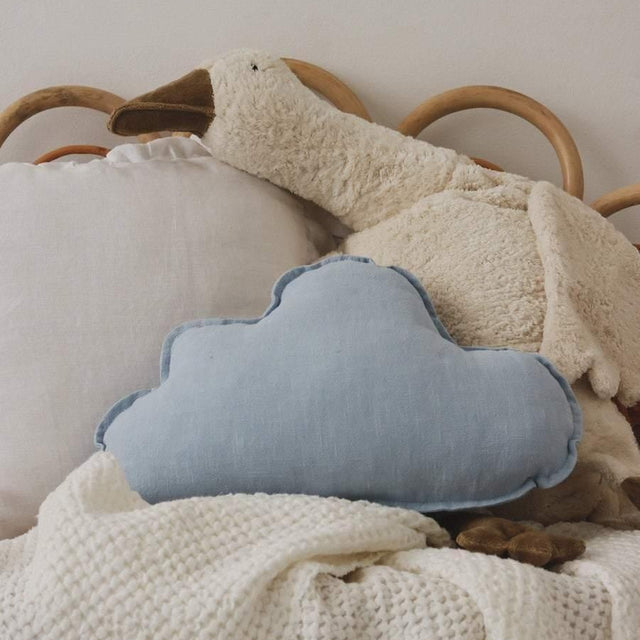Children's room with a cloud-shaped pillow on a bed