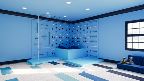 Medium Out of the Blue playroom climbing wall bundle with extended panels, multiple routes, and safety mats for kids.