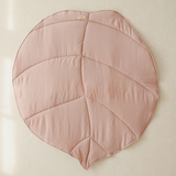 Pink leaf-shaped cushion on a beige background