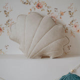 Decorative shell-shaped pillows and a banner on a floral background